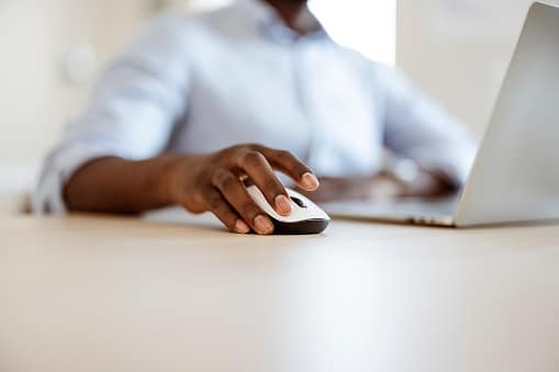 Business person clicking a computer mouse 