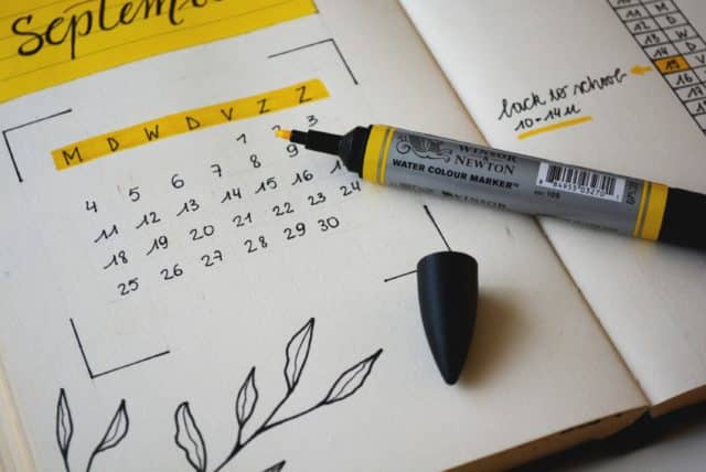 september calendar - yellow and white; yellow pen