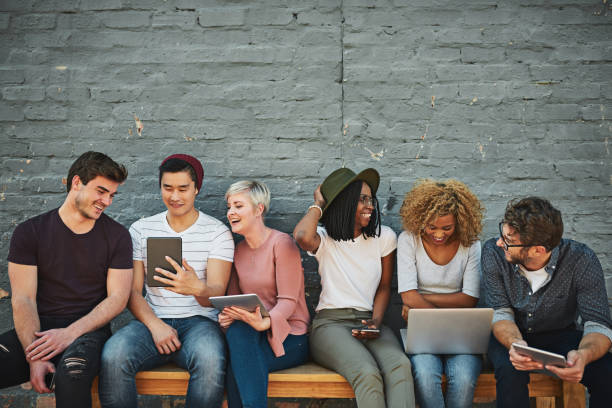 Shot of a diverse group of people social networking outside