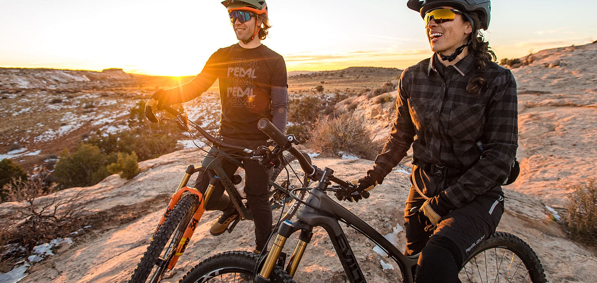 man and women riding bikes in helmets and sunglasses. Desert setting