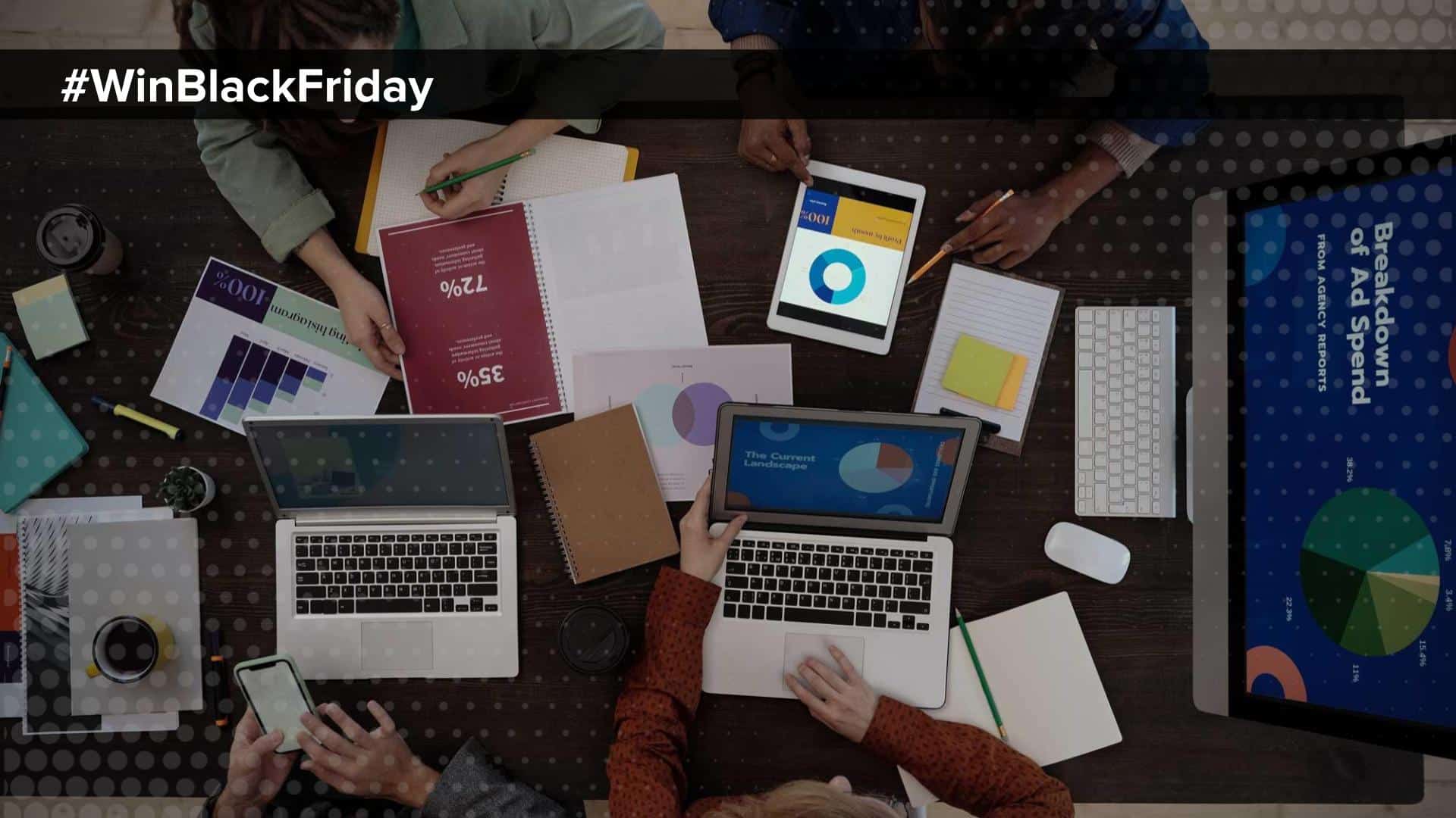 Ecommerce Reports: Plan Black Friday Sales _ Searchspring _ #WinBlackFriday _ two laptops, 4 people sitting at a table with reporting and data in front of them