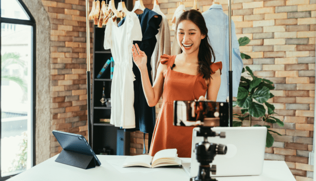 influencer showing clothing on rack for a post black friday promotion