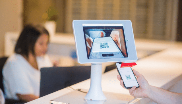 QR Code at kiosk - searchspring headless blog digital touchpoints