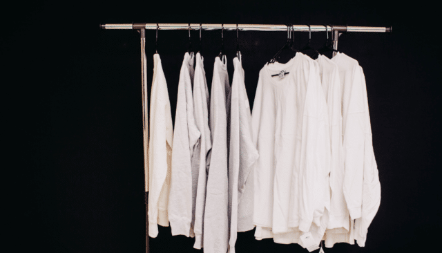 white sweatshirts hanging up 